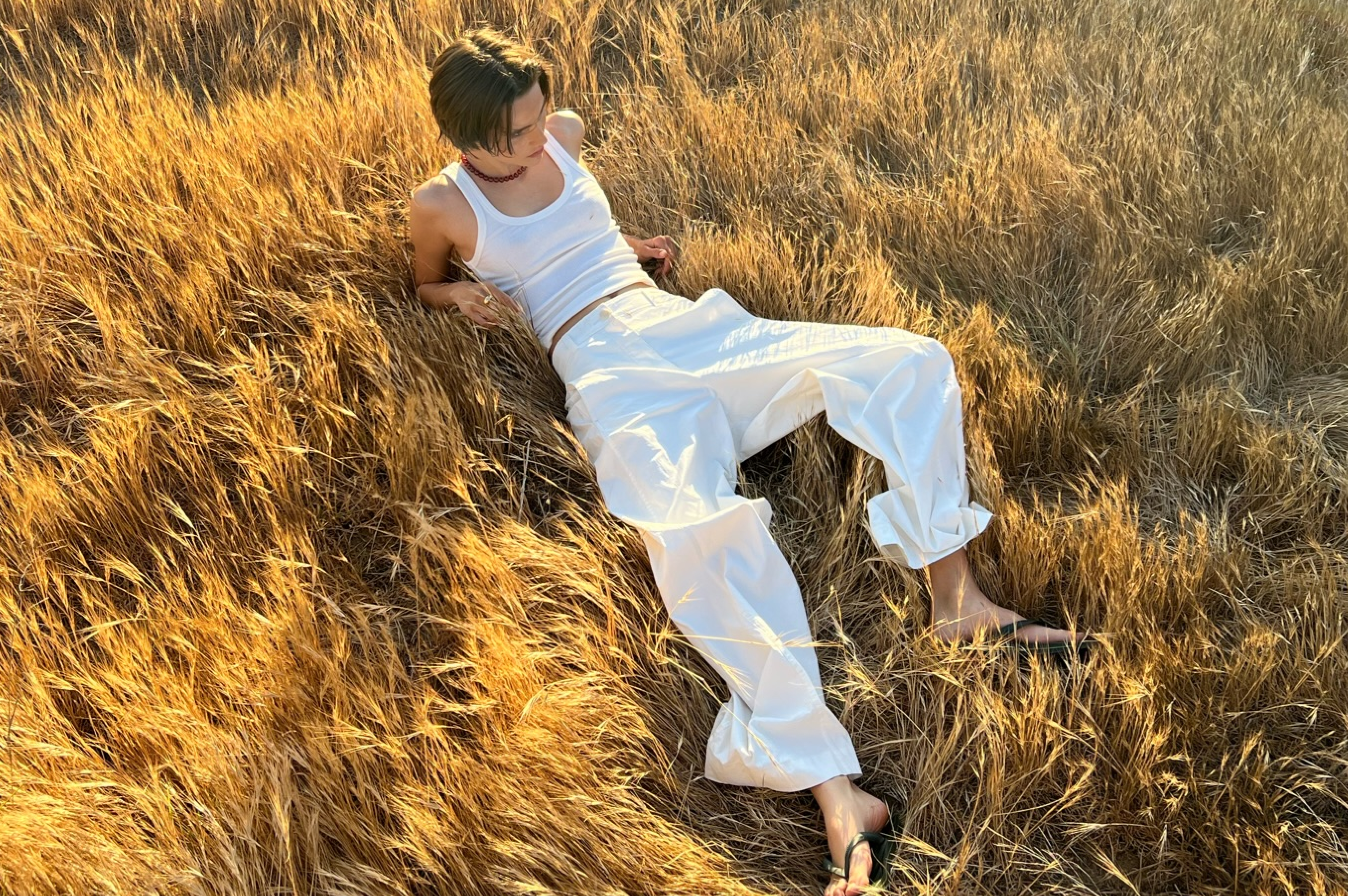 Mikkeline wearing the Rose Necklace while shooting in a golden corn field