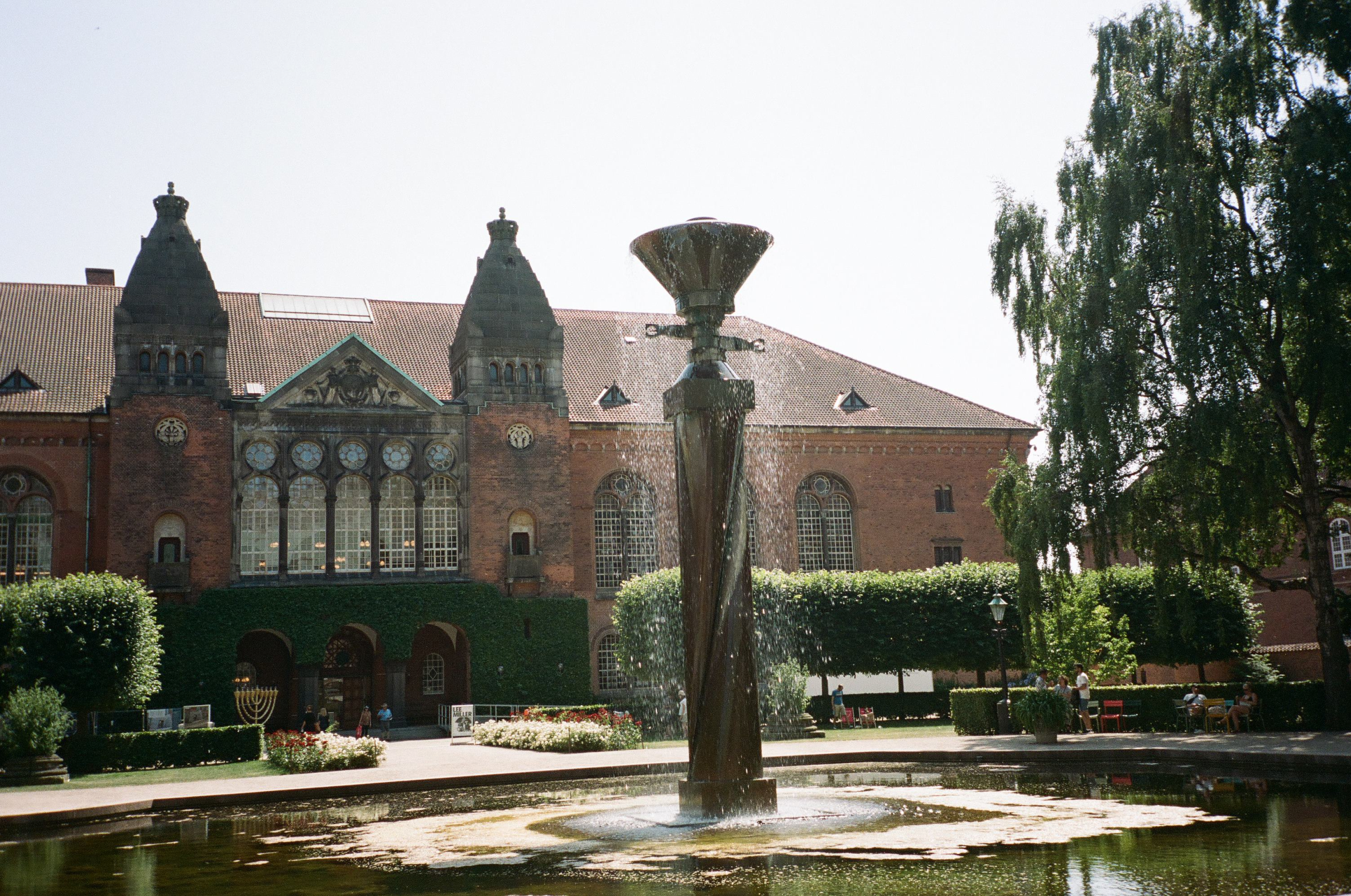 The water sculpture is an eight-meter-high column fountain with fish swimming below in the pond.